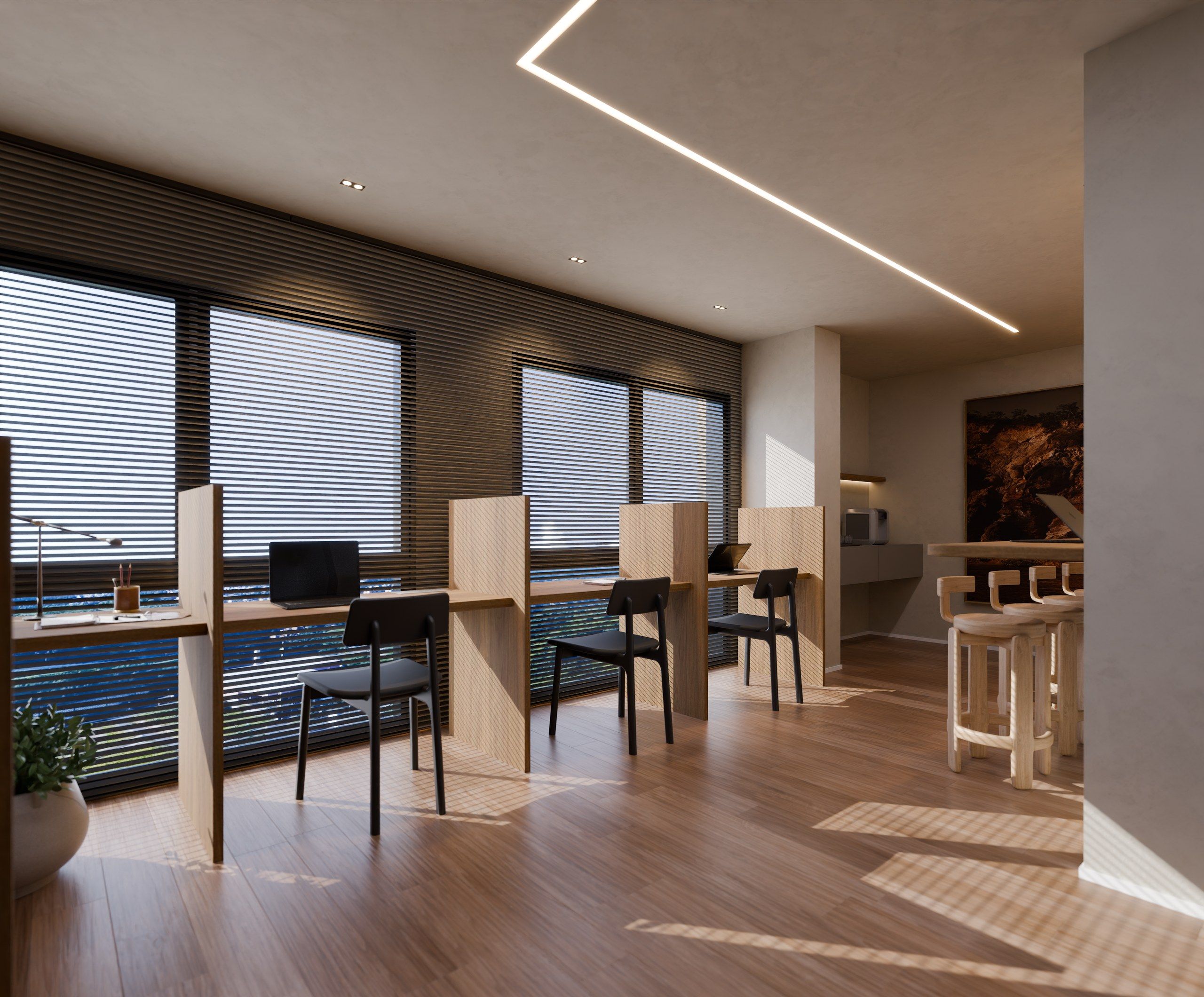 Espaço coworking com estações de trabalho individuais e bancada