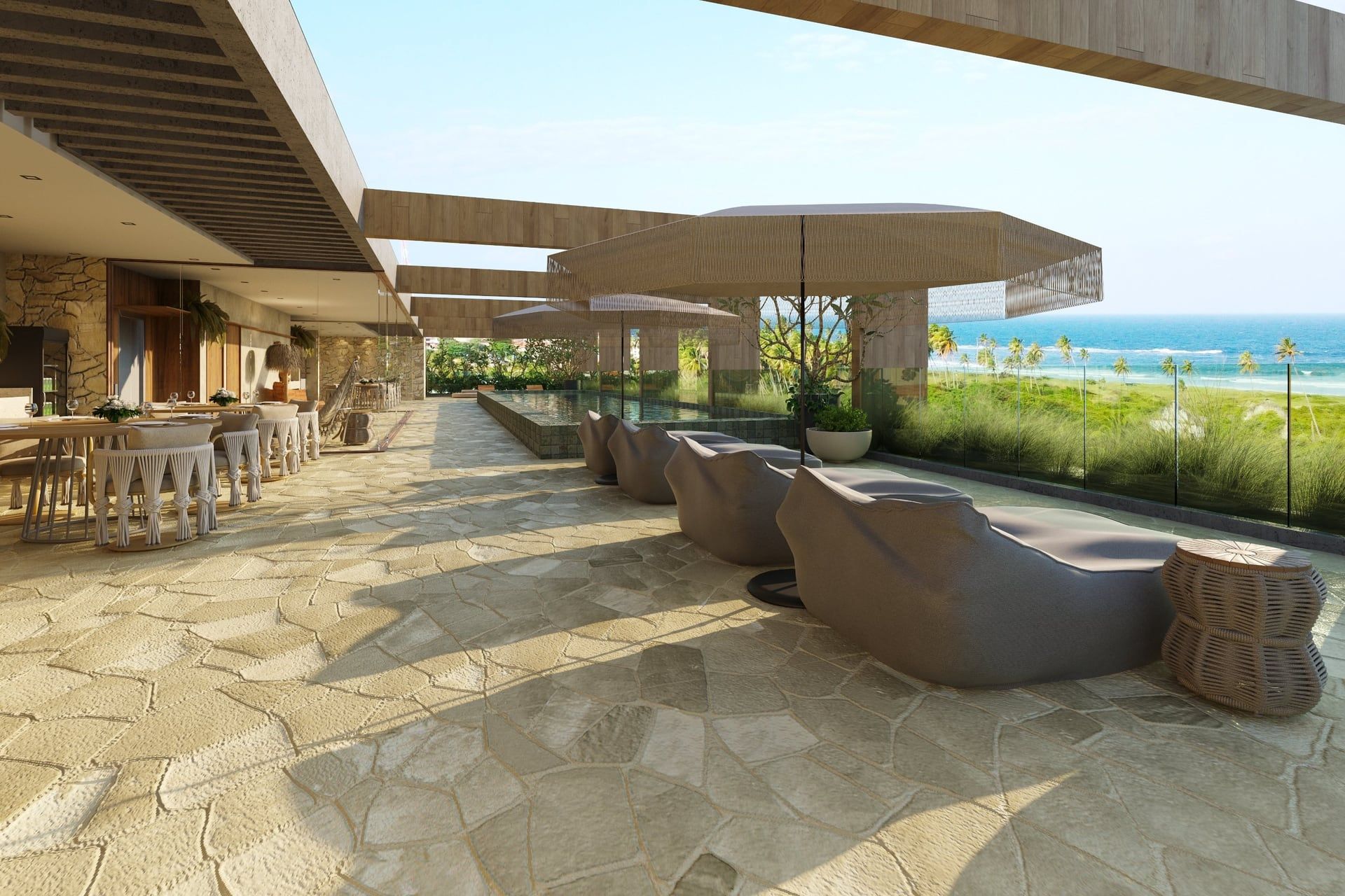 Rooftop com espaço gourmet, piscina e estar ao ar livre, de frente para o mar.