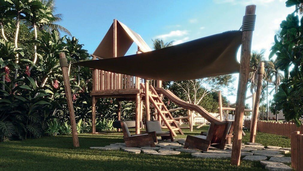 Playground do condomínio, em meio ao paisagismo tropical.