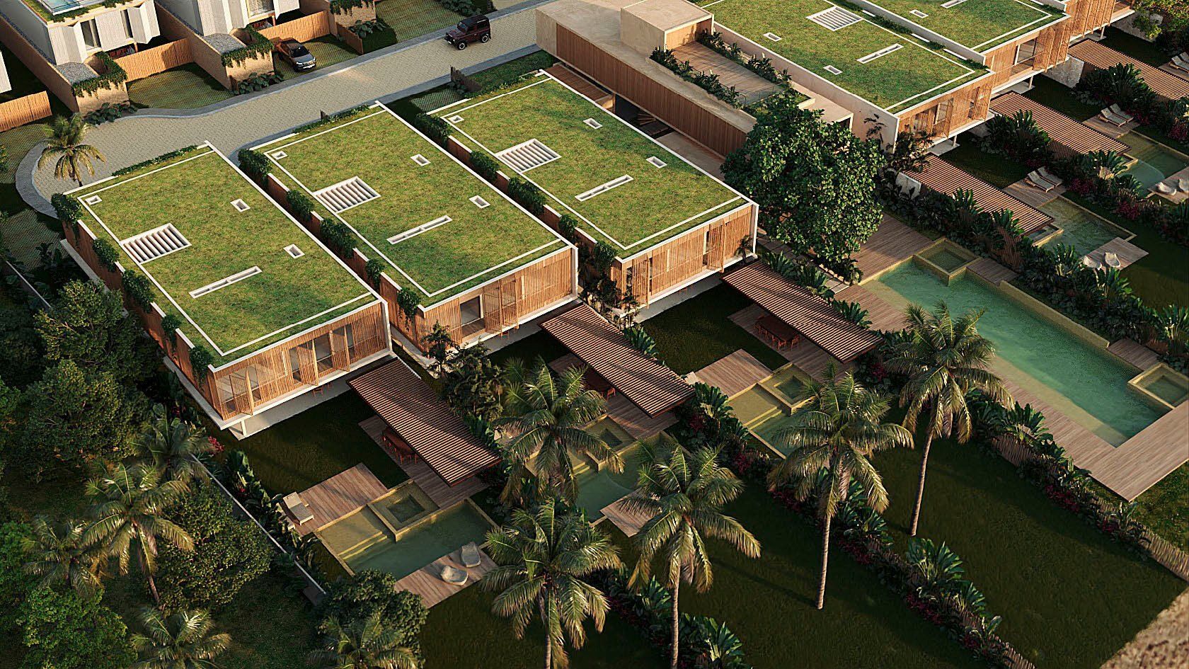 Telhados verdes e piscinas privativas das villas, vistos do alto.