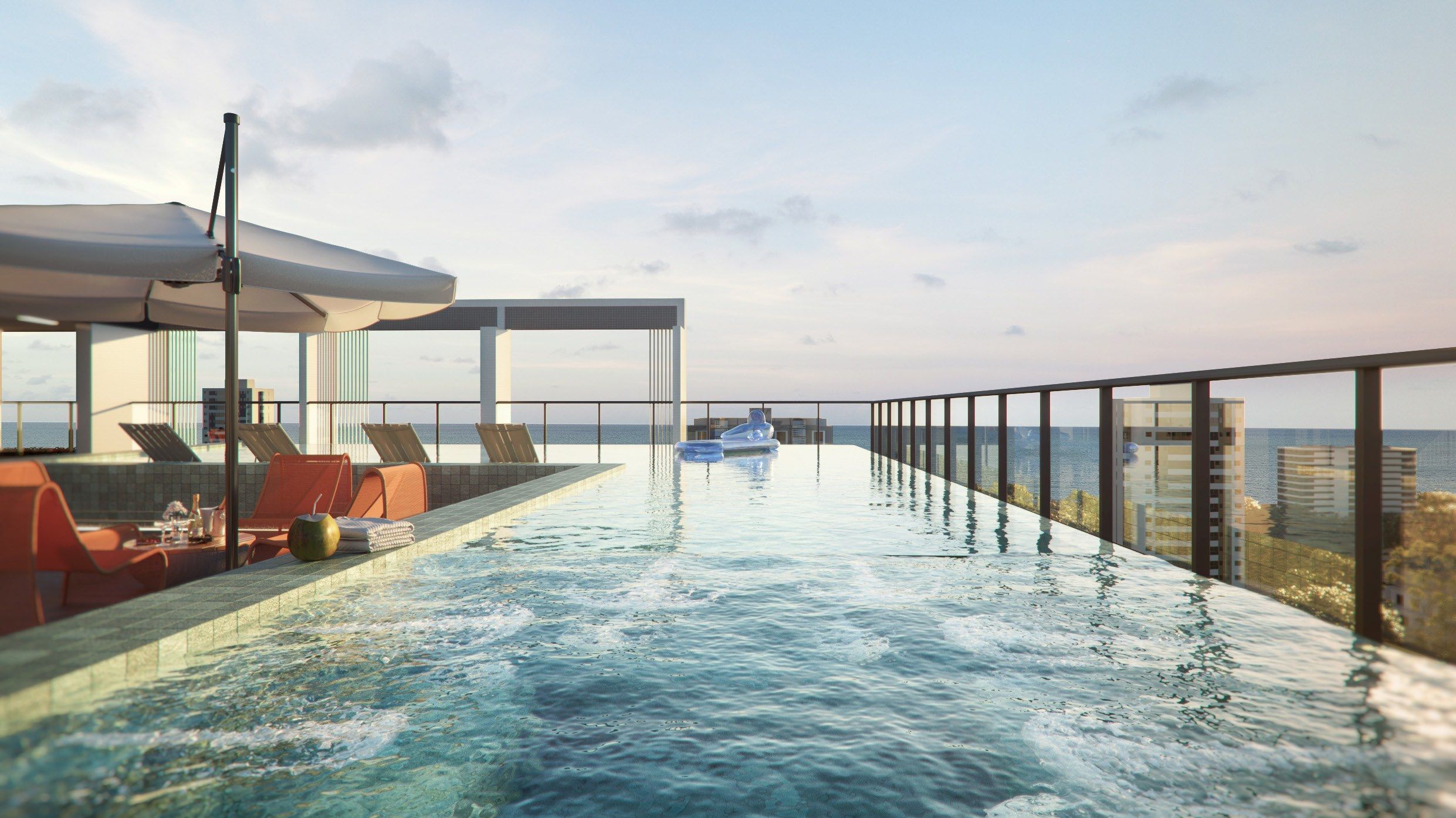 Piscina infinity com vista para o mar e área de descanso