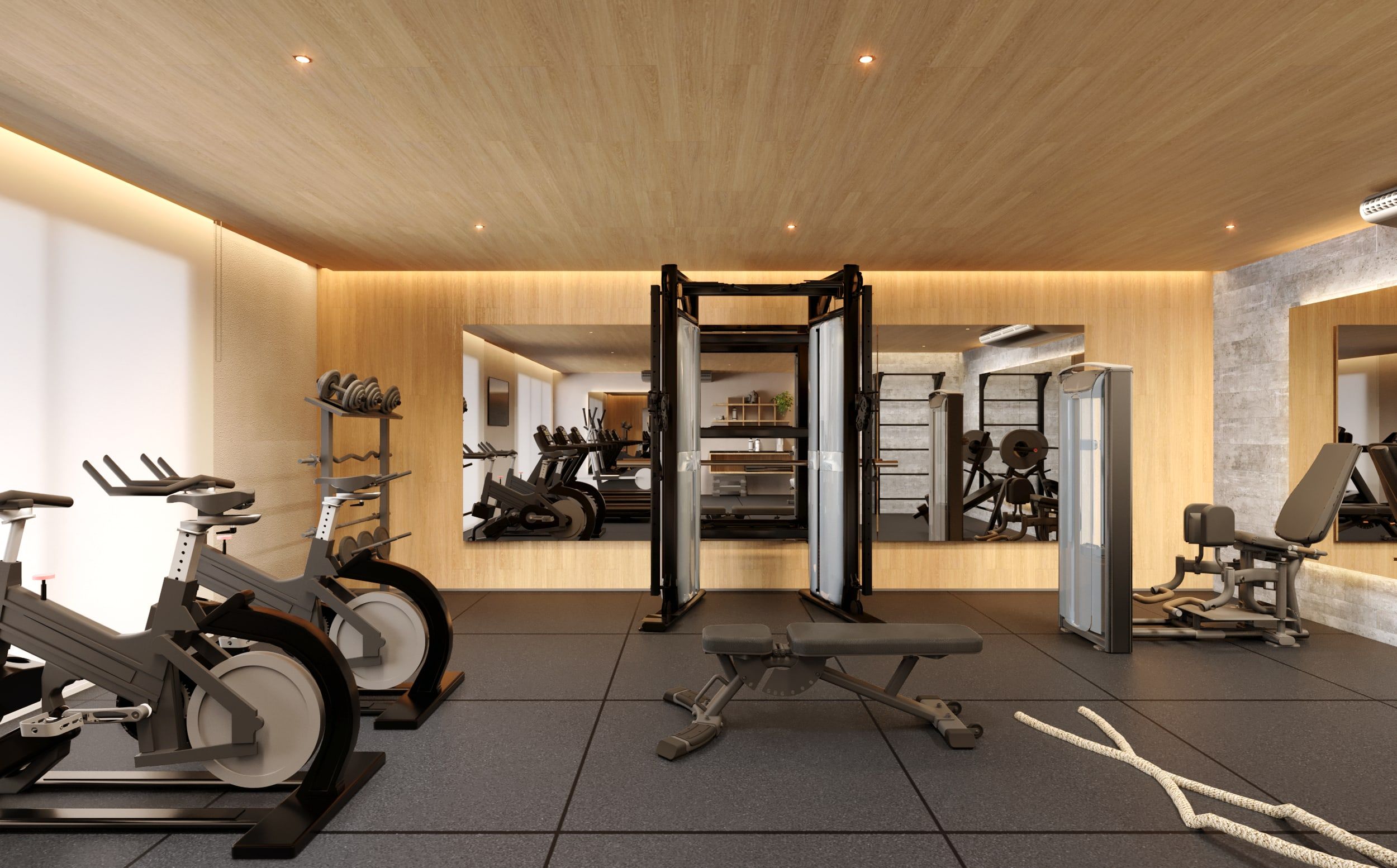 Academia equipada com bicicletas, rack de halteres e estação de musculação